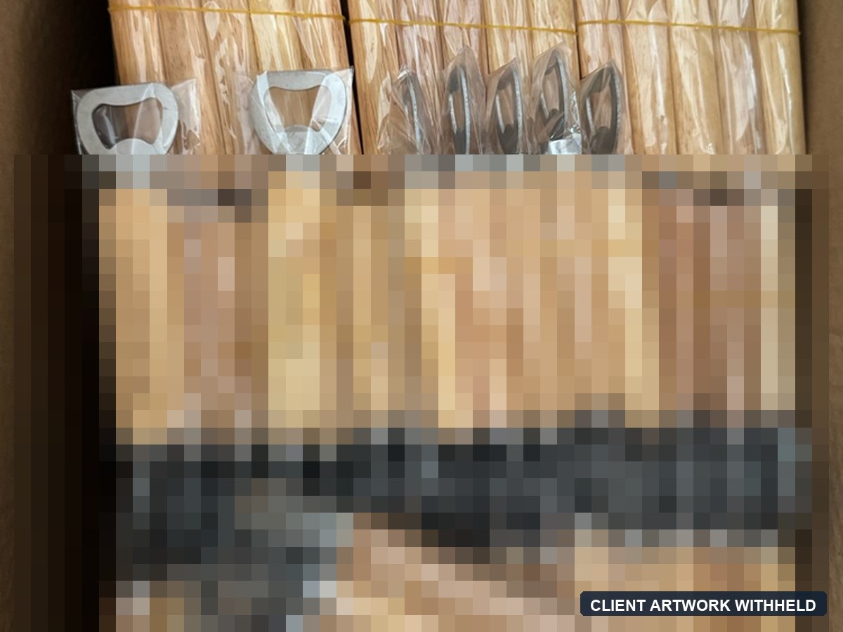 Wood-handle bottle openers packed for shipment.